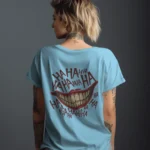 Back view of a woman wearing a light blue Joker T-shirt featuring a wide grin and red "HAHA" laughter graphics.