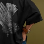 Back view of black streetwear t-shirt with praying hands and spiked bracelet print