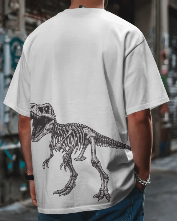 Man wearing an oversized white round neck cotton t-shirt with Jurassic World print, standing outdoors among cacti in a desert setting