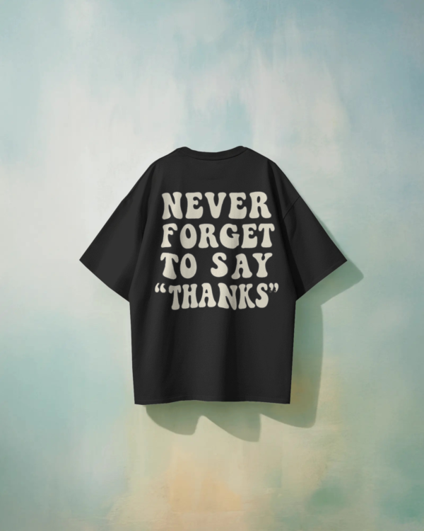 Black oversized unisex t-shirt with bold back print “Never Forget to Say Thanks,” made from 100% eco-friendly cotton