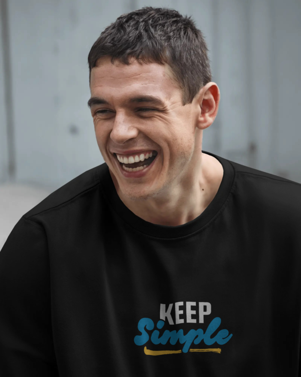 Black oversized unisex t-shirt with bold back print “keep simple,” made from 100% eco-friendly cotton